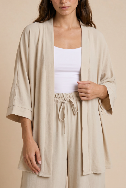 https://whitetie.gr/wp-content/uploads/2026/04/brunette_beige_crepe_kimono_set_sitting_floor_angled.png