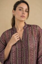 Mao Tencel Shirt in Burgundy – Μπλούζα με Mao Γιακά & Ιδιαίτερα Κουμπιά Χαρακτηριστικά Προϊόντος Σύνθεση: 95% Tencel – 5% lycra Ύφασμα: Λεπτό, σταθερό Tencel Υφή: Απαλή και λεία, με ανάλαφρη αίσθηση Γραμμή: Άνετη – relaxed fit Μέγεθος: One Size – καλύπτει από Small έως Extra Large Μανίκια: Φαρδιά, τρουακάρ  Οδηγίες Φροντίδας Για τη διατήρηση της υφής, των χρωμάτων και των ιδιαίτερων διακοσμητικών λεπτομερειών του Tencel, προτείνεται ήπια φροντίδα. 30°C – Πλύσιμο σε κρύο νερό, σε πρόγραμμα για ευαίσθητα, εφόσον το επιτρέπει η ετικέτα. Ήπιο στύψιμο ή χωρίς στύψιμο, για την προστασία του υφάσματος και των διακοσμητικών κορδονιών. ⊠ Όχι στεγνωτήριο. □ Φυσικό στέγνωμα στη σκιά, μακριά από άμεση ηλιακή ακτινοβολία. Πλύσιμο από την ανάποδη πλευρά, κατά προτίμηση μέσα σε ειδική θήκη προστασίας. Αποφύγετε την έντονη τριβή και το τράβηγμα των διακοσμητικών κόμπων.
